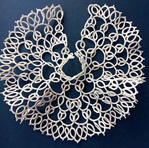 Anniversary lace for wedding glasses — white tatting skirt displayed on deep blue cloth, by FairyLacefromElena