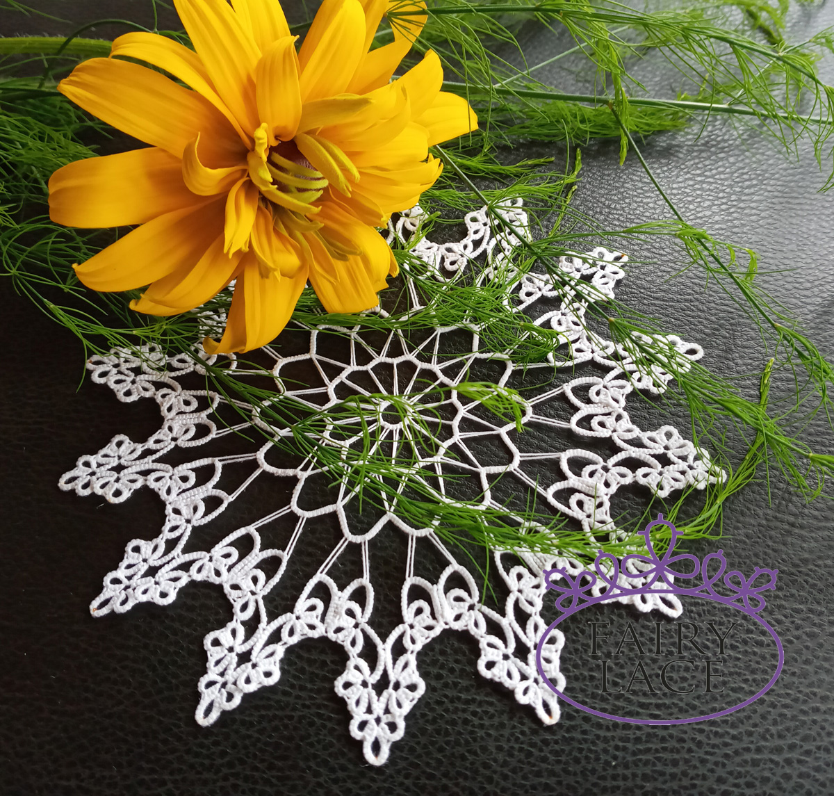 White lace doily "Mr. Sun, Mr. Moon" displayed on a black background with an orange flower and green leaves adding a sunny accent — from FairyLacefromElena.