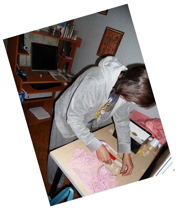 Workspace with tatting shuttles and threads, showing a large pink vest in cro-tatting technique. Handmade lace project by FairyLacefromElena