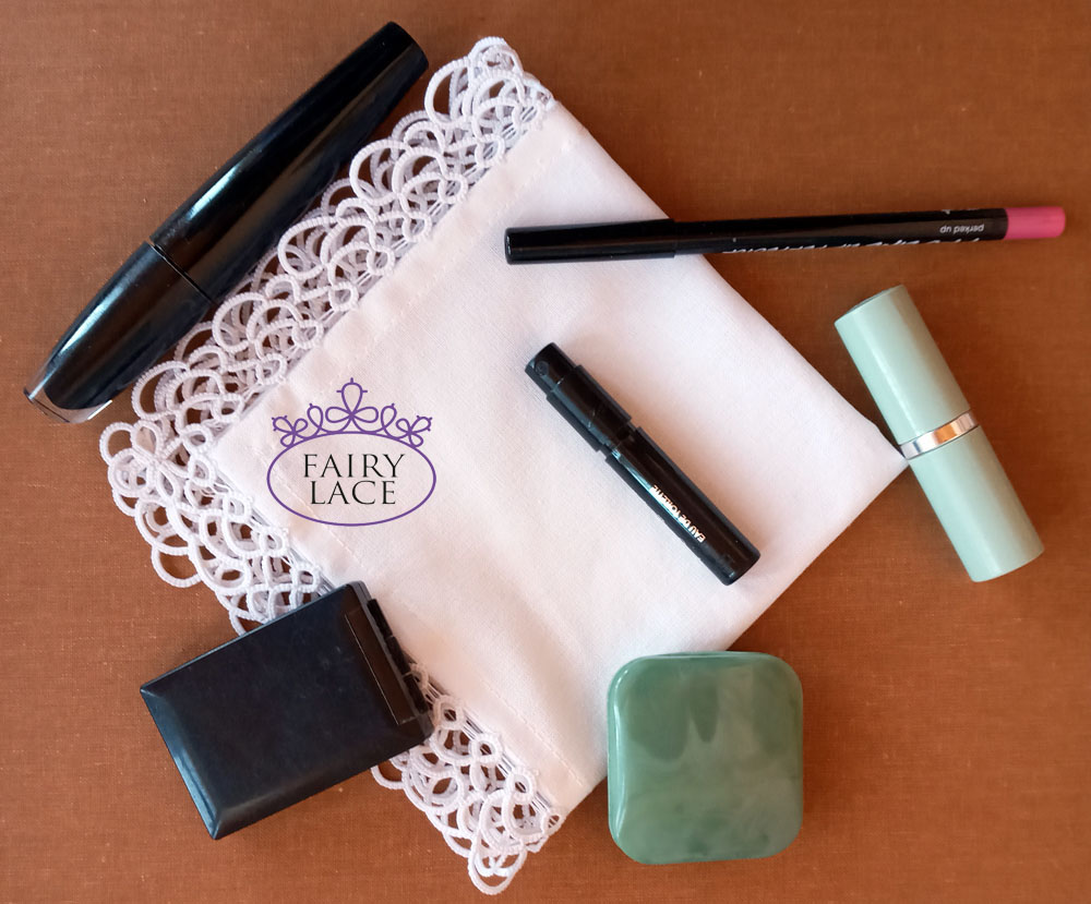 Flat lay of cosmetics and lace handkerchief by FairyLacefromElena on terracotta background