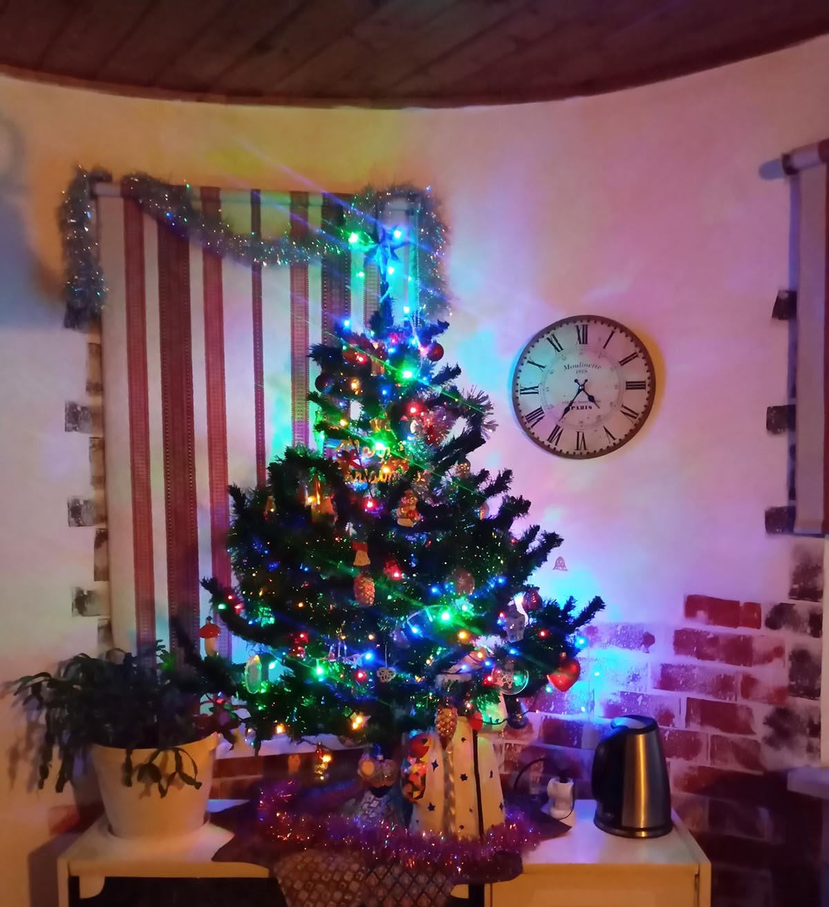 Small decorated Christmas tree in a Ukrainian home, festive holiday corner with handmade ornaments, photo by FairyLacefromElena